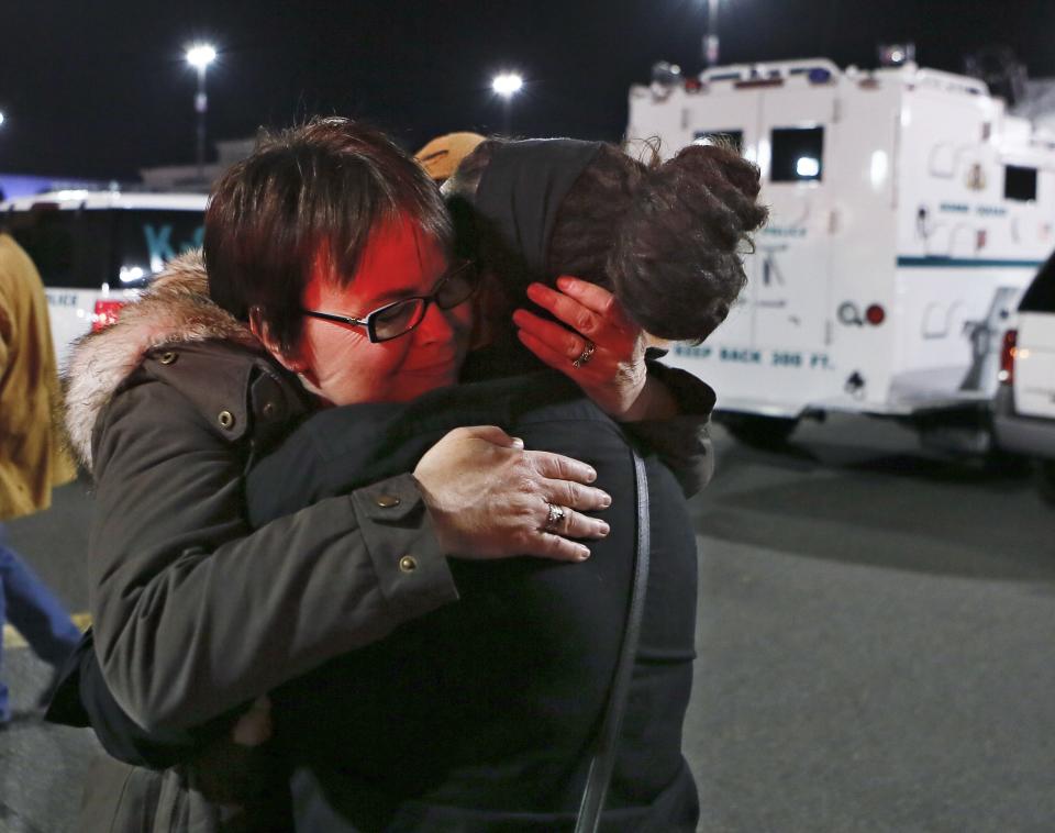 People embrace after police initiated a lockdown following reports that a gunman fired shots at the Garden State Plaza mall in Paramus