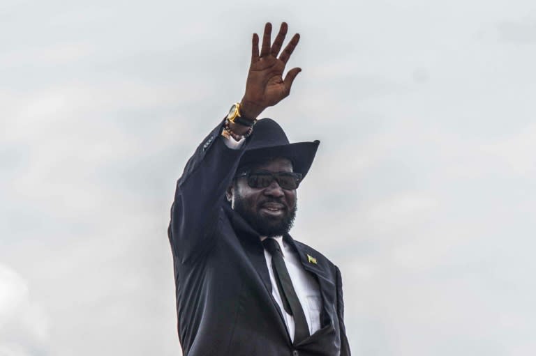 Kiir, wearing his trademark hat, waves at Juba airport before heading for Addis