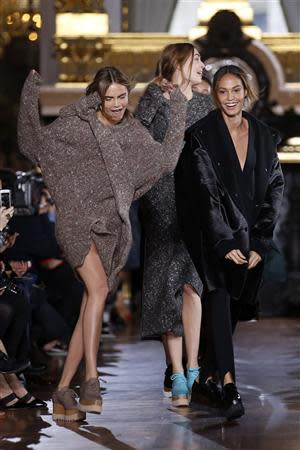 Models Cara Delevingne (L) and Joan Smalls (R) present creations by British designer Stella McCartney as part of her Fall/Winter 2014-2015 women's ready-to-wear collection show during Paris Fashion Week March 3, 2014. REUTERS/Benoit Tessier