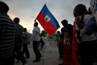 <p>Haitian-Americans carry Haitian flags and signs as they march to commemorate the eighth anniversary of the Haitian earthquake, Friday, Jan. 12, 2018, in Miami, Fla. (Photo: Wilfredo Lee/AP) </p>