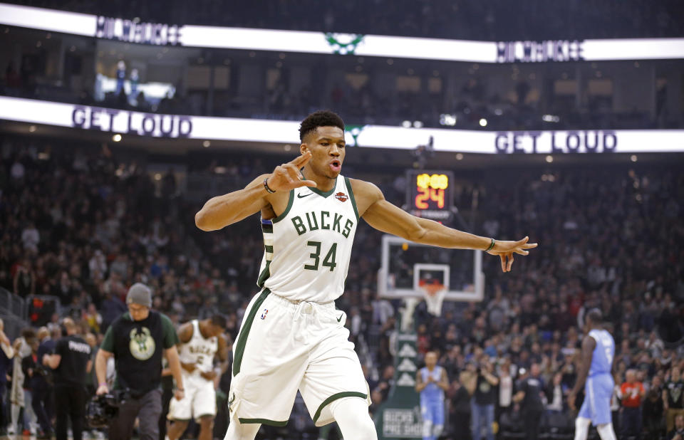 Milwaukee Bucks' Giannis Antetounmpo gets ready for the opening tip of the team's NBA basketball against the Minnesota Timberwolves on Wednesday, Jan. 1, 2020, in Milwaukee. The Bucks won 106-104. (AP Photo/Jeffrey Phelps)