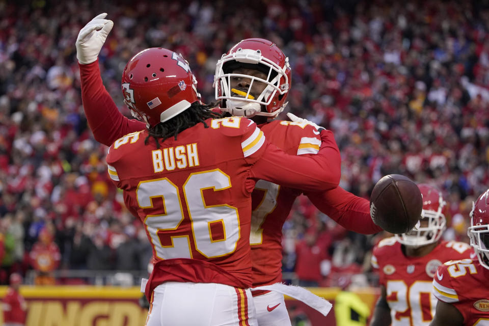 Kansas City Chiefs safety Chamarri Conner is congratulated by teammate Deon Bush (26) after intercepting a pass during the first half of an NFL football game against the Buffalo Bills Sunday, Dec. 10, 2023, in Kansas City, Mo. (AP Photo/Ed Zurga)