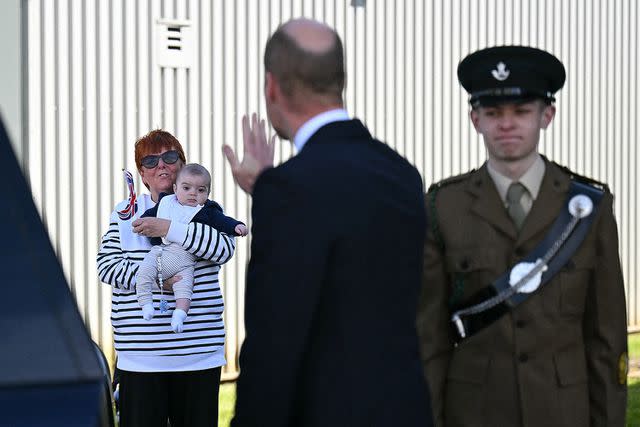 <p>OLI SCARFF/POOL/AFP via Getty</p> Prince William gives a wave to Andrea Newton and her grandson after visiting Low Carbon Materials in Seaham, England on April 30, 2024.