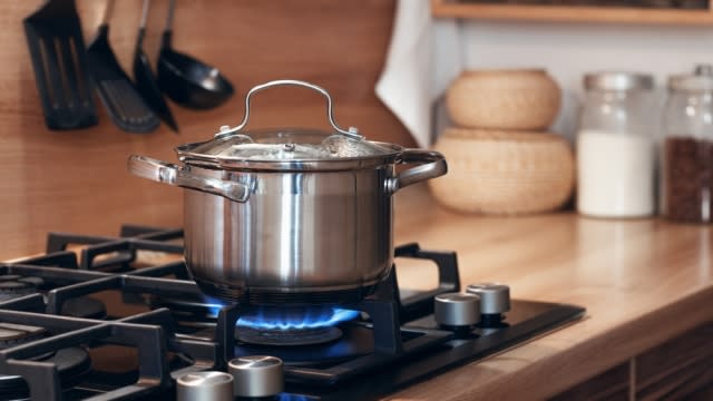 A pot sits on a gas burner.