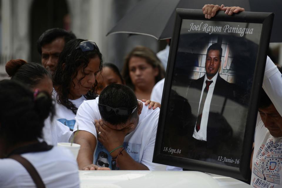 <p>Relatives of Joel Rayon Paniagua, one of the victims of the shooting at the Pulse night club in Orlando, mourn over his coffin during his funeral at a cemetery in Cordoba, in Veracruz state, Mexico, June 24, 2016. (REUTERS/Oscar Martinez) </p>