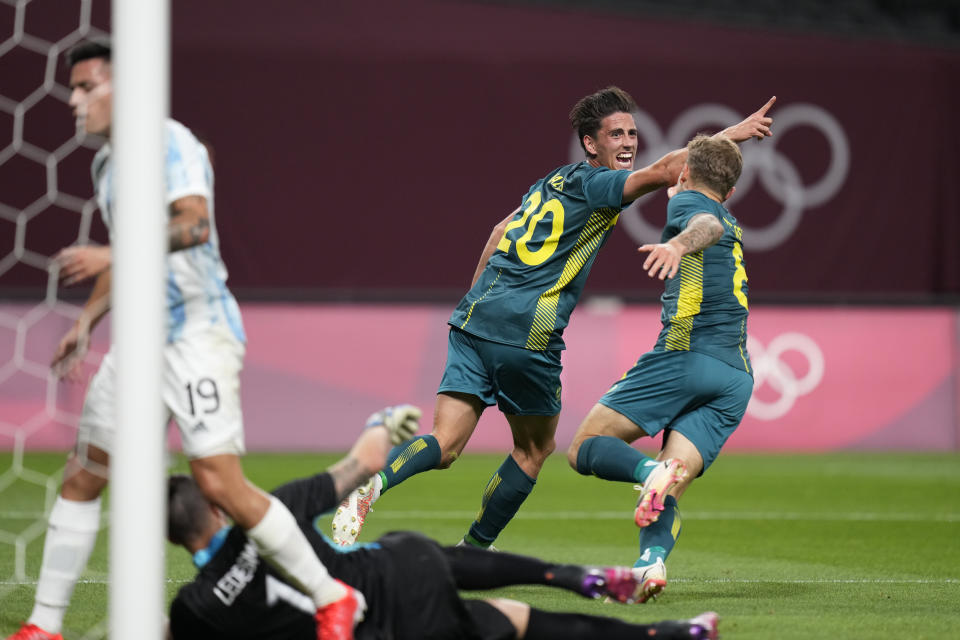 Australia's Lachlan Wales celebrates scoring his side's opening goal against Argentina during a men's soccer match at the 2020 Summer Olympics, Thursday, July 22, 2021, in Sapporo, Japan. (AP Photo/SIlvia Izquierdo)