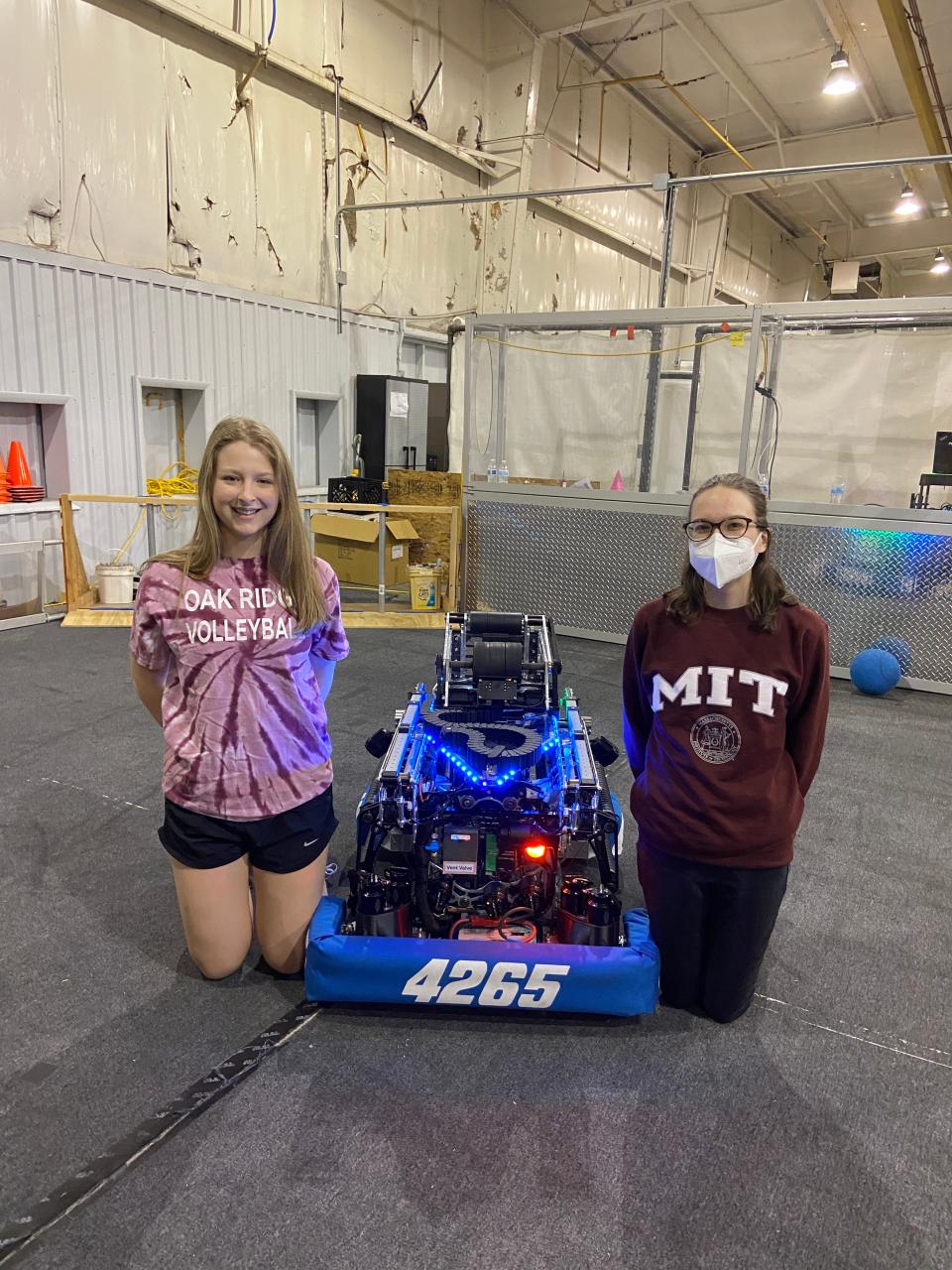 Alex Shanafield and Amelie Nagle with the Secret City Wildbots’ competition robot they helped create.