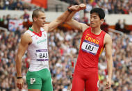 China's Liu Xiang (R) has his arm held up by Hungary's Balazs Baji after crashing into the first hurdle during their men's 110m hurdles round 1 heat at the London 2012 Olympic Games at the Olympic Stadium August 7, 2012. Liu experienced deja vu of the most agonising kind on Tuesday when the Achilles injury that forced him out of the high hurdles heats in Beijing four years ago ended his London Olympics campaign at the same stage. REUTERS/Lucy Nicholson (BRITAIN - Tags: SPORT OLYMPICS ATHLETICS)