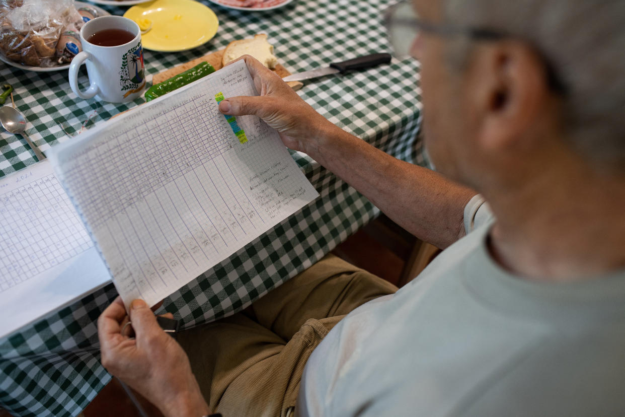 Ferenc Szepe, 68, looks at the records of monthly rainfall on his farm near Jaszszentlaszlo, Hungary, June 1, 2022. Farmers across Hungary have reported 