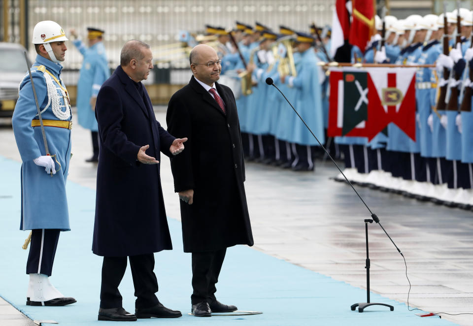 Turkey's President Recep Tayyip Erdogan, left, and Iraq's President Barham Salih inspect a military honour guard before their talks in Ankara, Turkey, Thursday, Jan. 3, 2019. The two were expected to discuss bilateral and regional issues, including Syria.(AP Photo/Burhan Ozbilici)