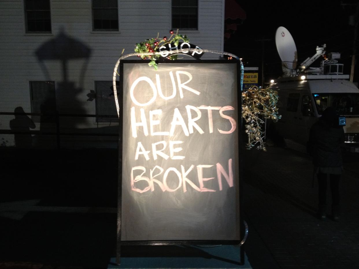 A message outside a restaurant in Newtown, Conn., reads: Our hearts are broken.