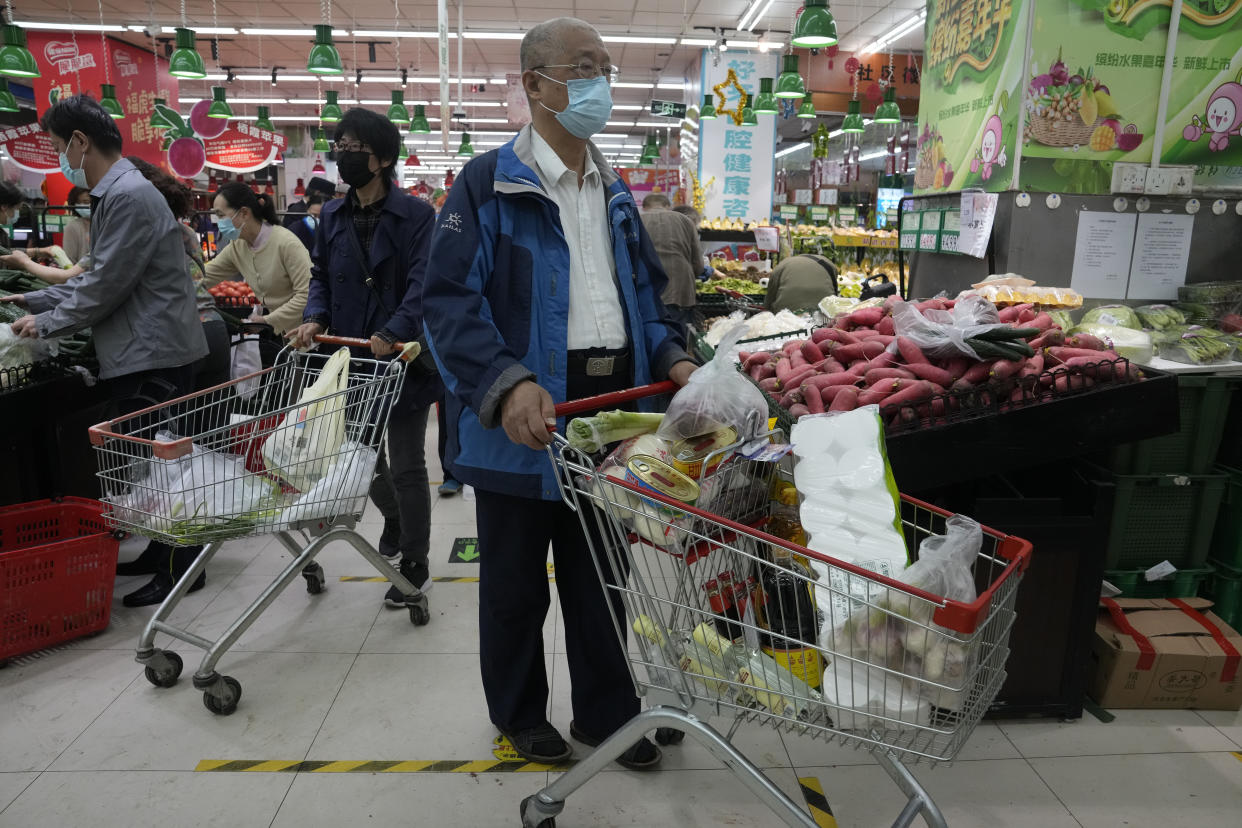 Residents wearing masks shop at a supermarket in the Chaoyang district of Beijing, Monday, April 25, 2022. Mass testing started Monday in Chaoyang district, home to more than 3 million people in the Chinese capital, following a fresh COVID-19 outbreak. (AP Photo/Ng Han Guan)