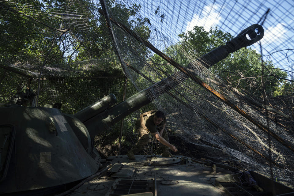 A Ukrainian serviceman of 30th brigade prepares his self propelled artillery to fire towards Russian position in Donetsk region, Ukraine, Tuesday, June 20, 2023. (AP Photo/Evgeniy Maloletka)