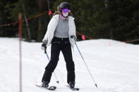 FILE - In this May 27, 2020, file photo, a skier wears a face covering while negotiating the slope at the reopening of Arapahoe Basin Ski Resort, which closed in mid-March to help in the effort to stop the spread of the new coronavirus, in Keystone, Colo. Roughly seven months after the coronavirus cut the ski season short at the height of spring break, resorts across the U.S. and Canada are slowly picking up the pieces and figuring out how to safely reopen this winter. (AP Photo/David Zalubowski, File)