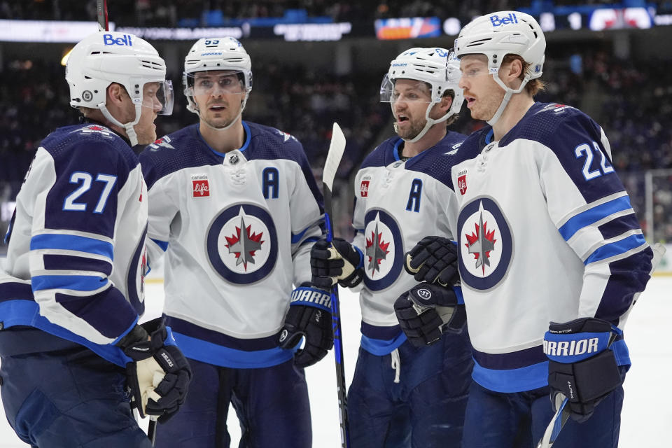 Winnipeg Jets' Mason Appleton (22) celebrates with teammates Nikolaj Ehlers (27), Mark Scheifele (55) and Neal Pionk after scoring a goal during the third period of an NHL hockey game against the New York Islanders, Saturday, March 23, 2024, in Elmont, N.Y. The Islanders won 6-3. (AP Photo/Frank Franklin II)