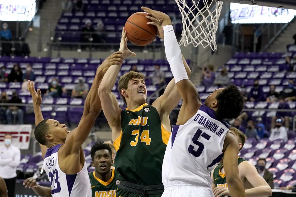 TCU forward Jaedon LeDee (23) and forward Chuck O'Bannon Jr. (5) combine to block a shot attempt by North Dakota State forward Rocky Kreuser (34) in the first half of an NCAA college basketball game in Fort Worth, Texas, Tuesday, Dec. 22, 2020. (AP Photo/Tony Gutierrez)