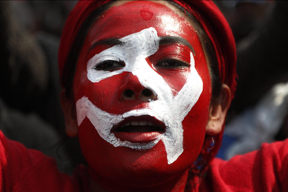 A Nepalese supporter of a splinter group in the governing Nepal Communist Party participates in a rally to celebrate the Supreme Court order in Kathmandu, Nepal, Wednesday, Feb. 24, 2021. Nepal's Supreme Court on Tuesday ordered the reinstatement of Parliament after it was dissolved by the prime minister, in a ruling likely to thrust the Himalayan nation into a political crisis. (AP Photo/Niranjan Shrestha)