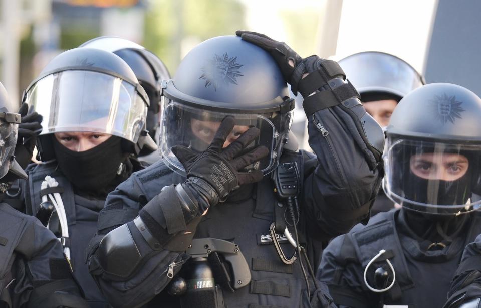 Police officers prepare, ahead of a left-wing demonstration, in Leipzig, Germany, Saturday, June 3, 2023. The demonstration is against the verdict in the trial of Lina E. The Dresden Higher Regional Court sentenced the student to five years and three months imprisonment. (Sebastian Willnow/dpa via AP)