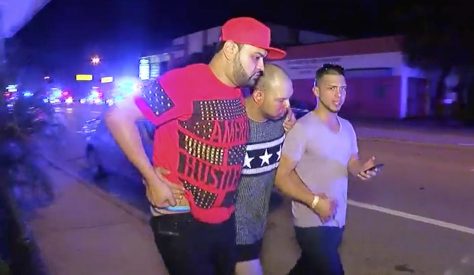 <p>An injured man is escorted out of the Pulse nightclub after a shooting rampage, Sunday morning June 12, 2016, in Orlando, Fla. (AP Photo/Steven Fernandez) </p>