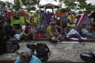 Central American migrants making their way to the U.S. rest in a park after arriving to Huixtla, Mexico, Monday, Oct. 22, 2018. Thousands of Central American migrants resumed an arduous trek toward the U.S. border Monday, with many bristling at suggestions there could be terrorists among them and saying the caravan is being used for political ends by U.S. President Donald Trump. (AP Photo/Moises Castillo)