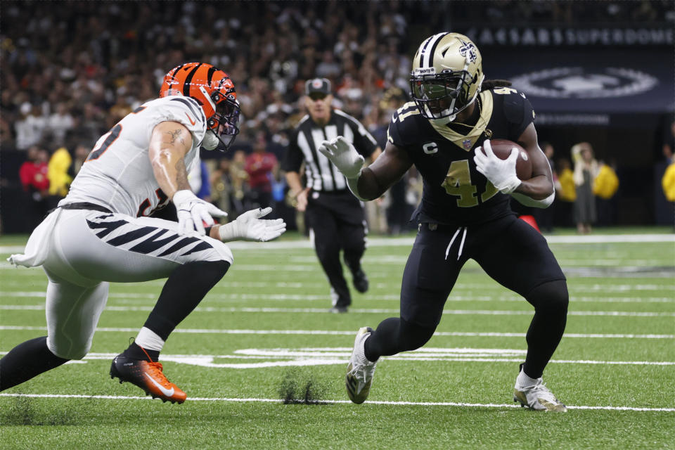 New Orleans Saints running back Alvin Kamara (41) runs as Cincinnati Bengals linebacker Logan Wilson (55) defends during the first half of an NFL football game in New Orleans, Sunday, Oct. 16, 2022. (AP Photo/Butch Dill)