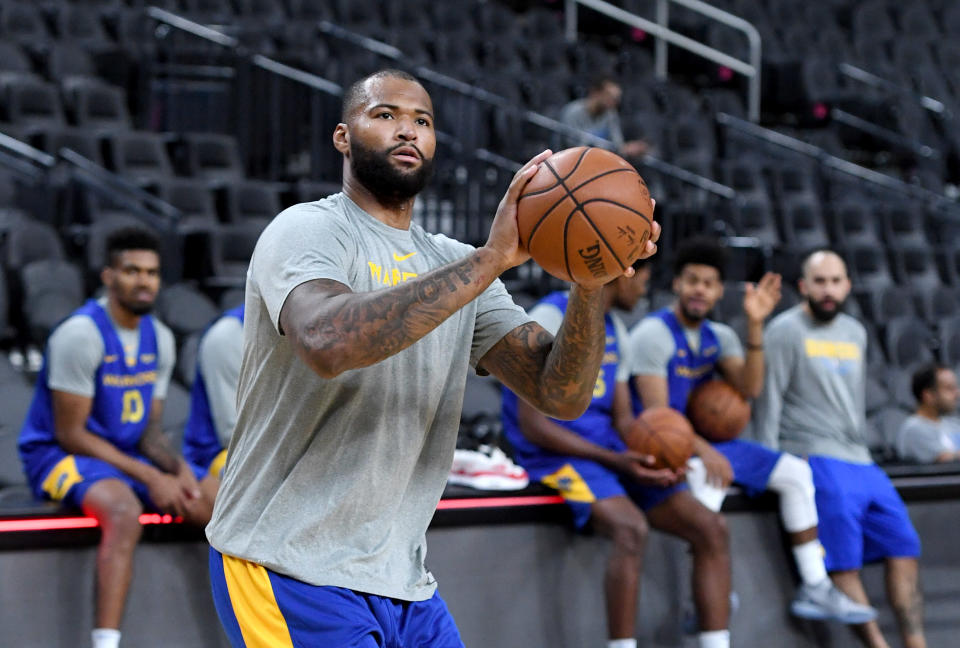 While on the bench in street clothes, DeMarcus Cousins was ejected from the Warriors game against the Knicks on Friday night. (Getty Images)
