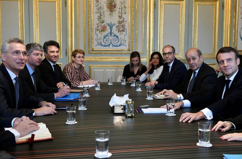 French President Emmanuel Macron and French Foreign Affairs Minister Jean-Yves Le Drian meet with NATO Secretary General Jens Stoltenberg at the Elysee Palace in Paris