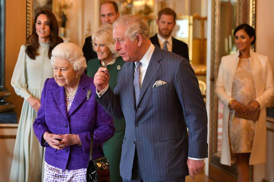 Britain's Prince Charles, Prince of Wales (C) walks with his mother Britain's Queen Elizabeth II