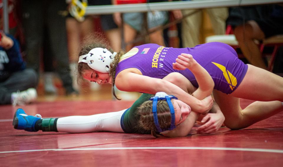 Hononegah's Angelina Cassioppi works to roll Emma Engels from Bartlett over onto her back during the IHSA girls sectional meet in Naperville on Saturday, Feb. 12, 2022. Cassioppi pinned Engels in the first period to take the sectional title for the 100-pound weight class.