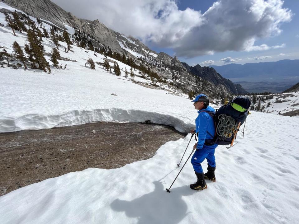 Guide Dave Miller surveys a stream exposed after a snow bridge collapsed on Mt. Whitney.