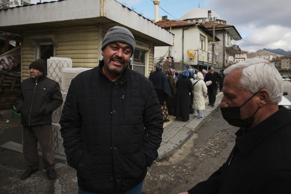 People wait to buy bread in an Ankara Municipality's bread kiosk in Mamak neighbourhood, in Ankara's suburb, Turkey, Wednesday, Dec. 1, 2021. Turkey’s beleaguered currency has been plunging to all-time lows against the U.S. dollar and the euro in recent months as President Recep Tayyip Erdogan presses ahead with a widely criticized effort to cut interest rates despite surging consumer prices. (AP Photo/Burhan Ozbilici)