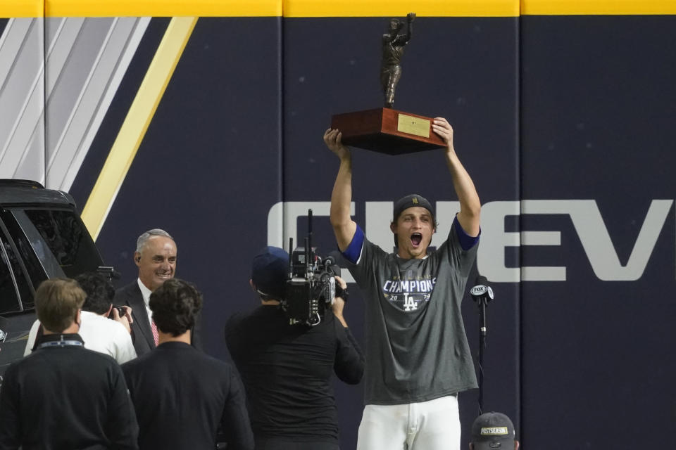 Los Angeles Dodgers shortstop Corey Seager holds up the MVP trophy after defeating the Tampa Bay Rays 3-1 to win the baseball World Series in Game 6 Tuesday, Oct. 27, 2020, in Arlington, Texas. (AP Photo/Tony Gutierrez)