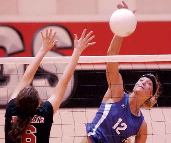 Watertown senior Marcelina Glab, right, pounds a spike against Brookings during a 2010 District 1AA volleyball match in Brookings.