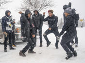 The combined North and Patrick Henry High School drum corps keeps warm in the parking lot Sunday, Feb. 10, 2019, before taking part in Sen. Amy Klobuchar's announcement to run for president from a snowy Boom Park, in Minneapolis. (Glen Stubbe/Star Tribune via AP)