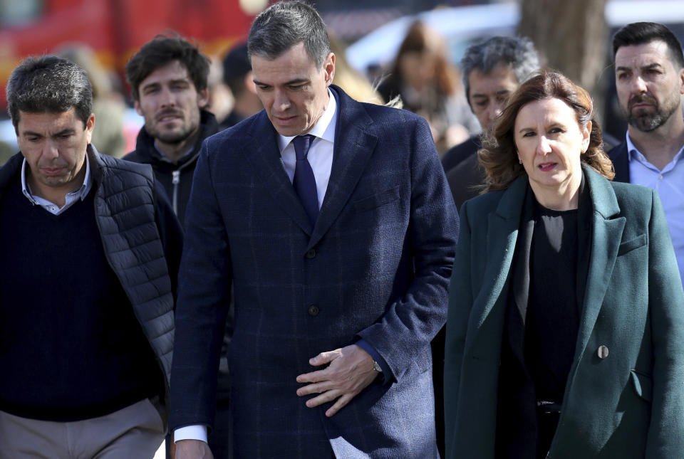 Spanish Prime Minister Pedro Sanchez arrives at the site of the fourteen-story building burned down in Valencia, Spain, Friday, Feb. 23, 2024. Firefighters continue cooling the skeleton of two residential buildings where they want to search for nearly 20 people missing after a fire intensified by strong winds spread quickly on Thursday night. 4 people died and 14 were injured. (AP Photo/Alberto Saiz)