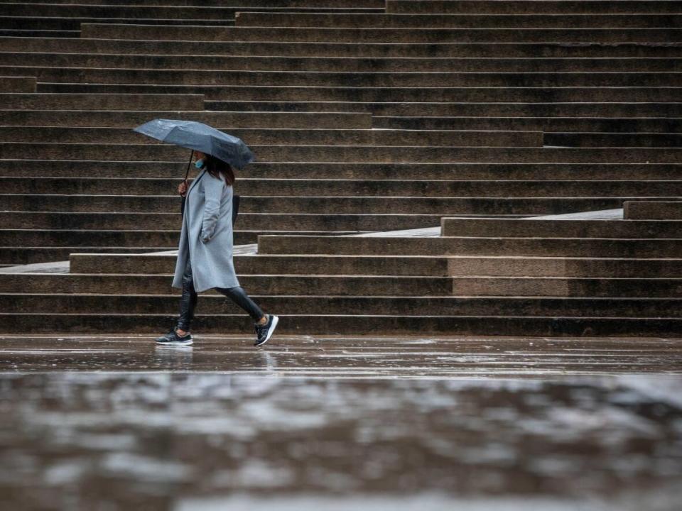 A woman braves the rain in Vancouver on Oct. 15.  (Ben Nelms/CBC - image credit)