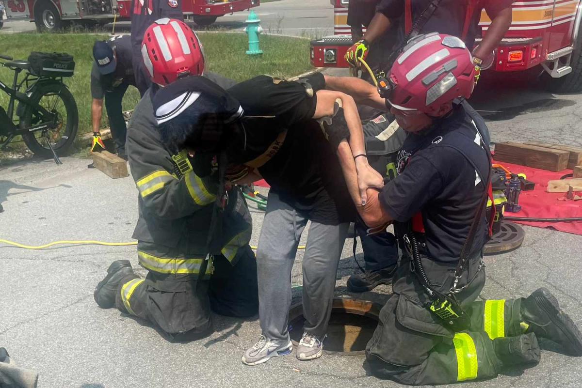 Firefighters Save Woman from Sewer After Police Saw Her Hand Sticking Up Through Manhole Cover image