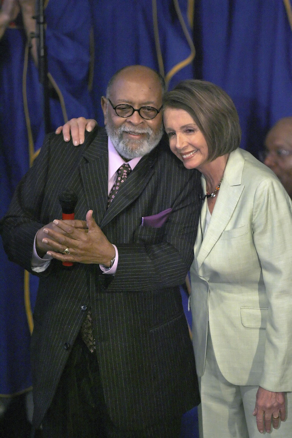 FILE - House Speaker Nancy Pelosi, right, hugs Reverend Cecil Williams before speaking about the passage of health insurance reform legislation to church members at Glide Memorial United Methodist Church in San Francisco on Sunday, March 28, 2010. Williams, who with his late wife turned Glide Church in San Francisco into a world-renowned haven for poor, homeless, and marginalized people, died Monday, April 22, 2024, at his home in San Francisco. He was 94. (AP Photo/Tony Avelar,File)