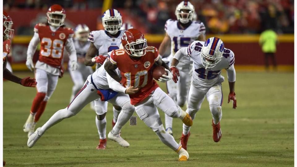 Kansas City Chiefs wide receiver Tyreek Hill jets down the field on a 46-yard punt return eluding Buffalo Bills defenders in the fourth quarter Sunday, January 23, 2022, at Arrowhead Stadium.