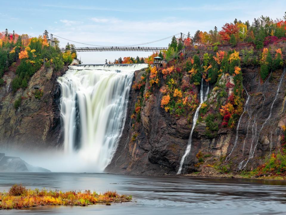 Montmorency Falls and Bridge, Quebec, in autumn with colorful trees.