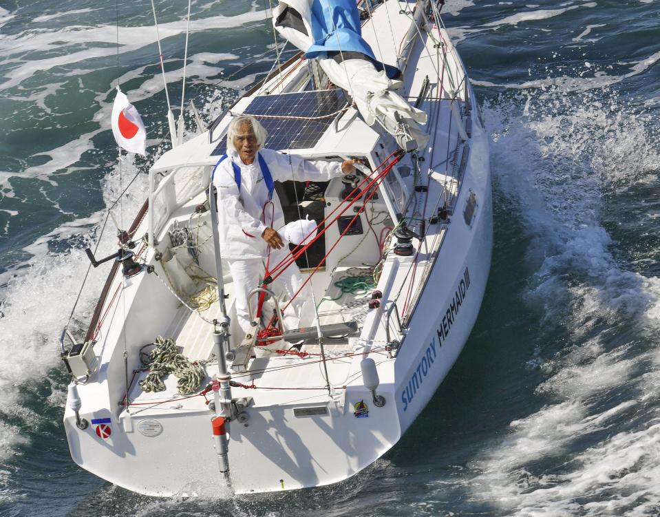 Japan's Kenichi Horie is seen on his sailing boat after his trans-Pacific sailing, at Osaka Bay, western Japan, Saturday, June 4, 2022. The 83-year-old Japanese adventurer returned home Saturday after successfully completing his solo, nonstop voyage across the Pacific, becoming the oldest person to reach the milestone.(Kyodo News via AP)