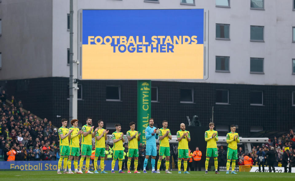 NORWICH, ENGLAND - MARCH 05: A 'Football stands together' message of support for Ukraine is displayed on the big screen as the Norwich City team applaudprior to the Premier League match between Norwich City and Brentford at Carrow Road on March 05, 2022 in Norwich, England. (Photo by Julian Finney/Getty Images)