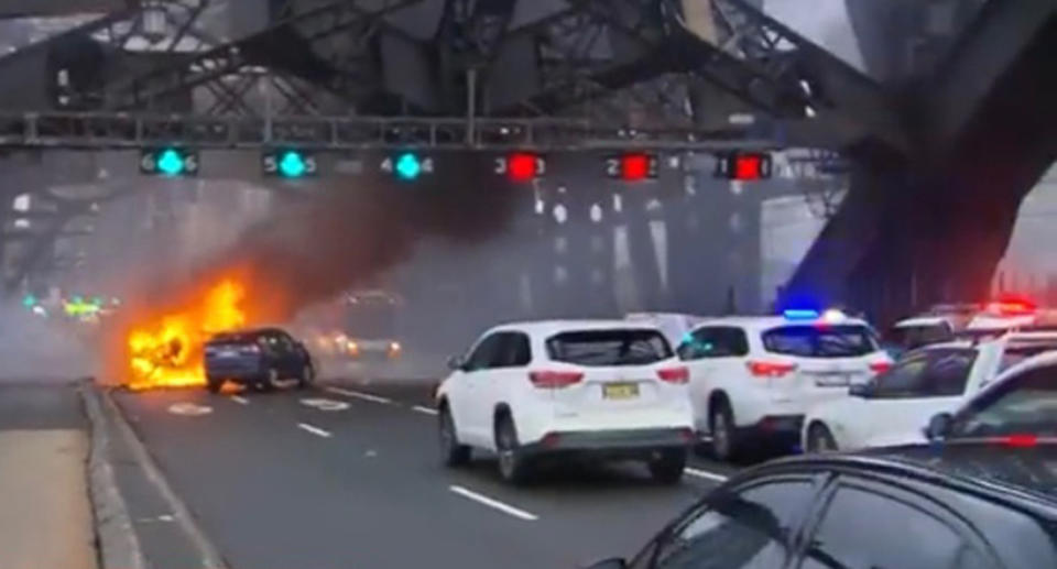 The car burst into flames on the Sydney Harbour Bridge on Monday morning. Source: 9News/ Anthony Segaert