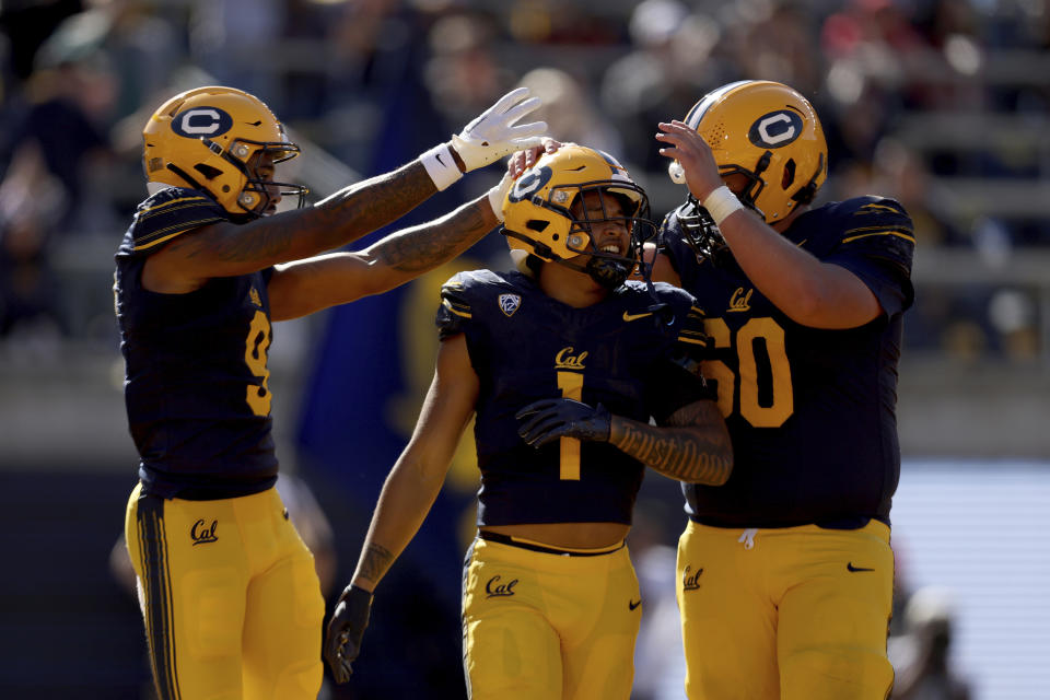 California running back Jaydn Ott (1) celebrates with wide receiver Taj Davis (9) and offensive lineman Brian Driscoll (60) after scoring a touchdown against Southern California during the first half of an NCAA college football game in Berkeley, Calif., Saturday, Oct. 28, 2023. (AP Photo/Jed Jacobsohn)