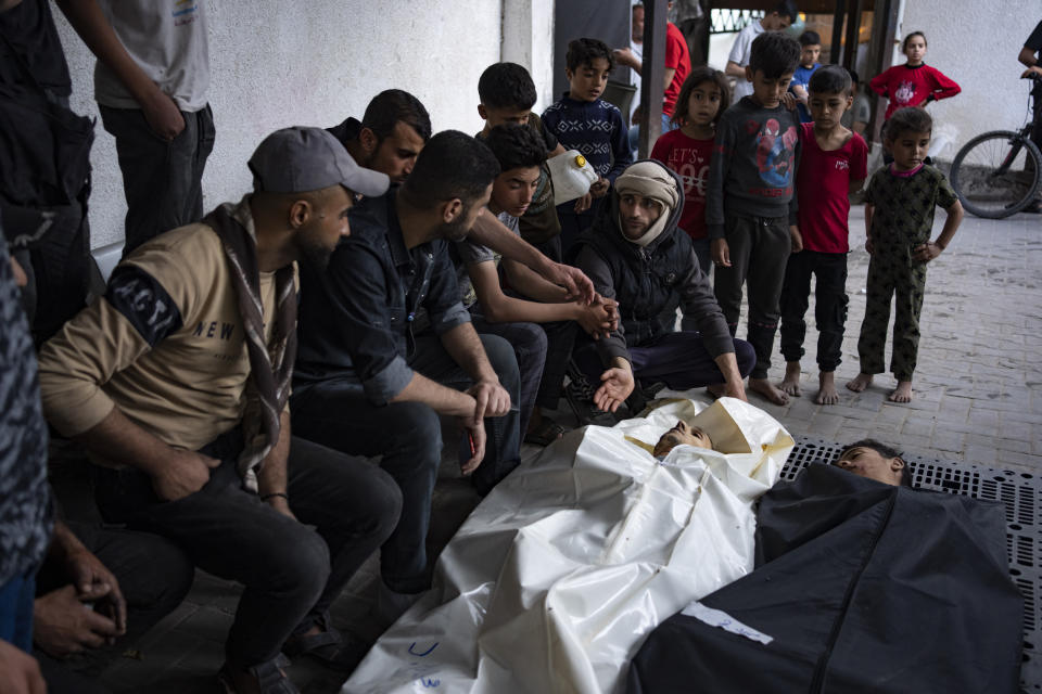 Palestinians mourn relatives killed in the Israeli bombardment of the Gaza Strip at a hospital morgue in Rafah, Monday, April 1, 2024. (AP Photo/Fatima Shbair)