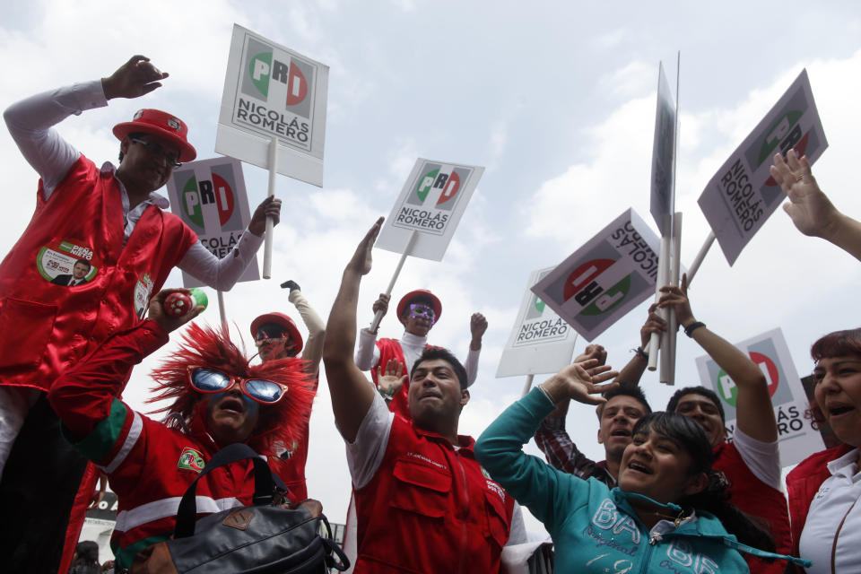 Supporters of Enrique Pena Nieto, presidential candidate of the opposition Institutional Revolutionary Party, PRI, cheer during a campaign rally at the Azteca stadium in Mexico City, Sunday, June 24, 2012. General elections in Mexico are scheduled for Sunday, July 1. (AP Photo/Esteban Felix)