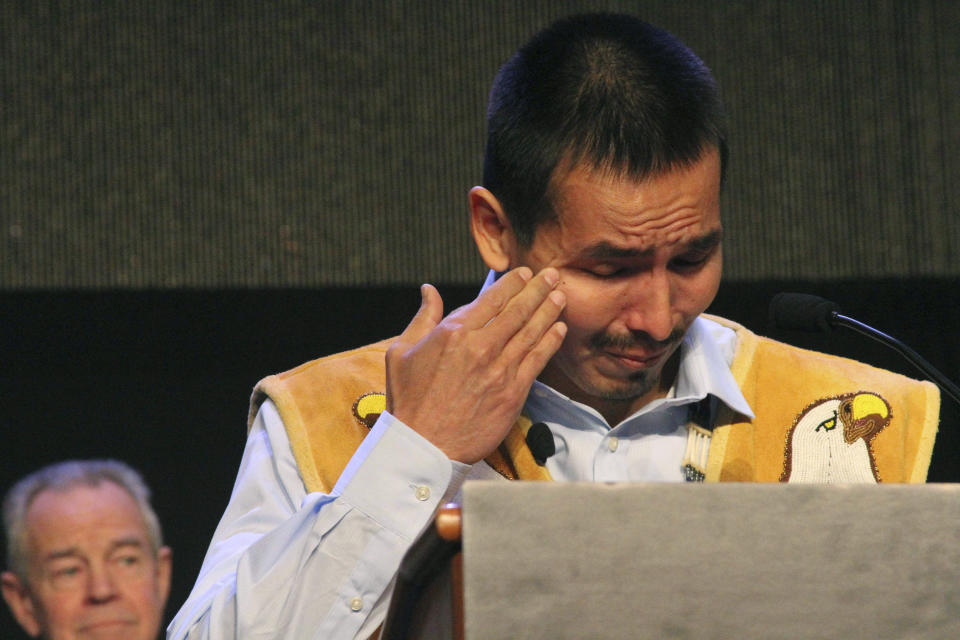 FILE - Marvin Roberts, one of the so-called Fairbanks Four, wipes his eye while addressing the Alaska Federation of Natives conference in Anchorage, Alaska, Saturday, Oct. 17, 2015. Roberts and three other men were convicted of killing a Fairbanks, Alaska teenager in 1997, but prosecutors vacated the convictions in 2015 after a key witness recanted testimony and a weeks-long federal review that included new evidence and testimony. The city of Fairbanks said Monday, Nov. 6, 2023, that it had settled with three of the four men for nearly $5 million. Roberts declined a settlement offer and his case is still pending. (AP Photo/Mark Thiessen, File)