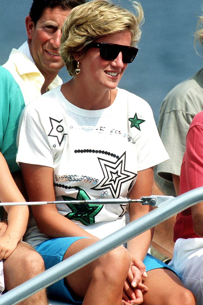 <p>We're very into this casual royal ensemble pairing boyish bright Bermuda shorts with a graphic sequin tee. Diana loved a gold earring like these heart baubles make even the most dressed down outfit look super glam. </p>