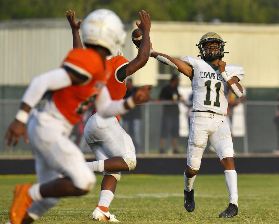 Fleming Island quarterback Cibastian Broughton (11) throws a pass in May's spring game against Mandarin. The schools face off in regular season action Friday.