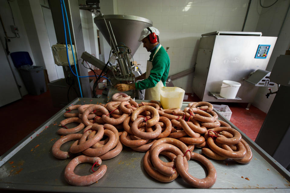 DELEITOSA, SPAIN - OCTOBER 29:  A worker prepares traditional chorizo sausages at the small family-run 'Sierra de las Villuercas' processing plant on October 29, 2015 in the village of Deleitosa, in Extramadura province, Spain.  The Spanish meat processing industry, which employs over 110,000 people, has been alarmed by the recent World Health Organization's announcement linking cancer to red meats and particularily processed meats like sausages.  (Photo by Denis Doyle/Getty Images)
